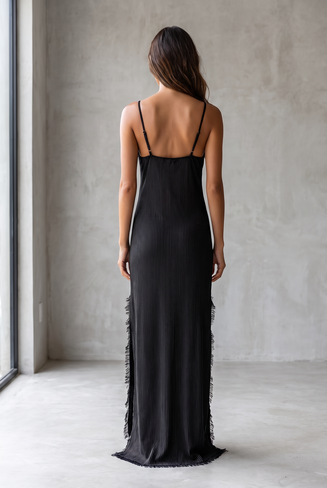Black pinstriped suspender maxi dress with frayed edges and slit hem - back view