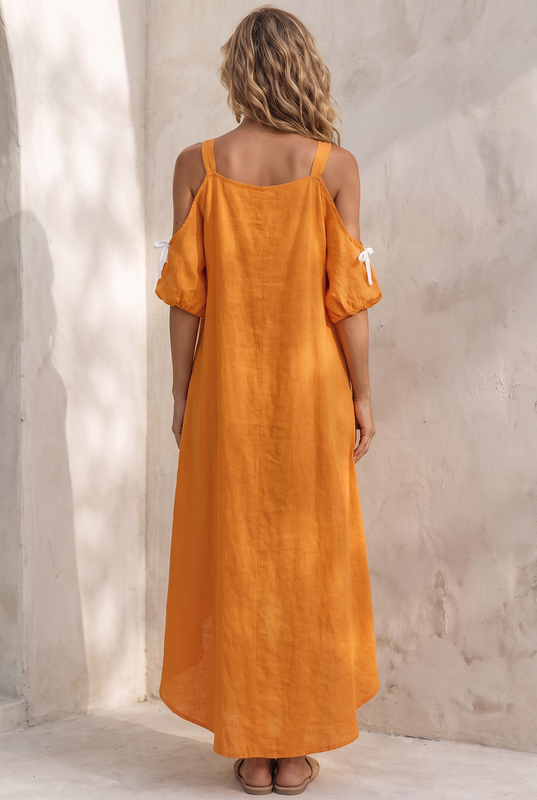 Tangerine linen dress with cold shoulder cutouts and high-low hem - back view